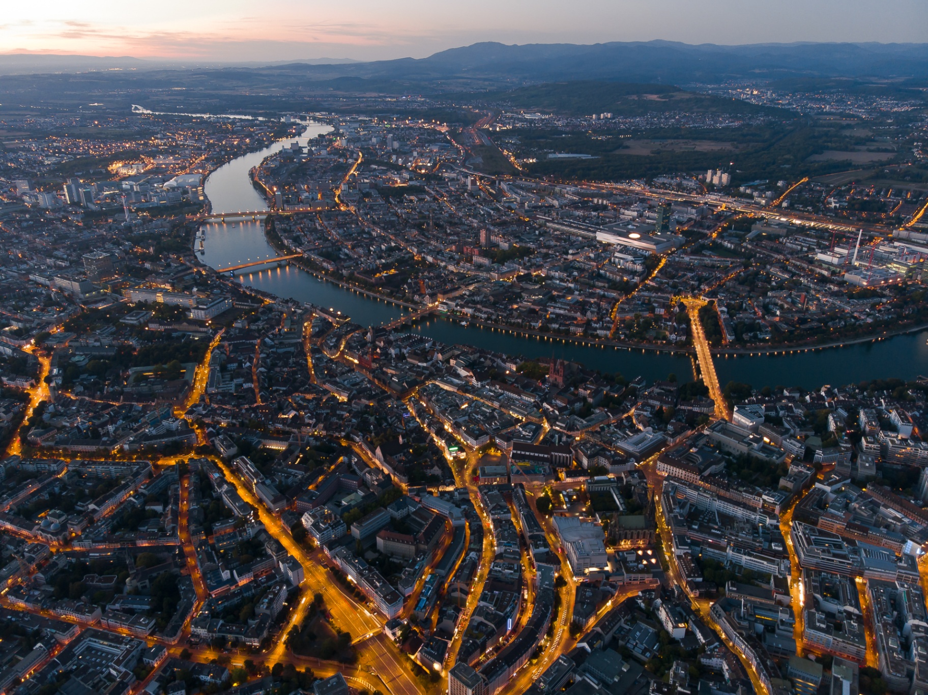 Dusk over Basel, the Rhine and its bridges.